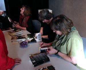 Janet Finn (MINING CHILDHOOD), Karen Buley (NANNY ON THE RUN), and Leah Joki (JUILLIARD TO JAIL) sign books at Butte Archives